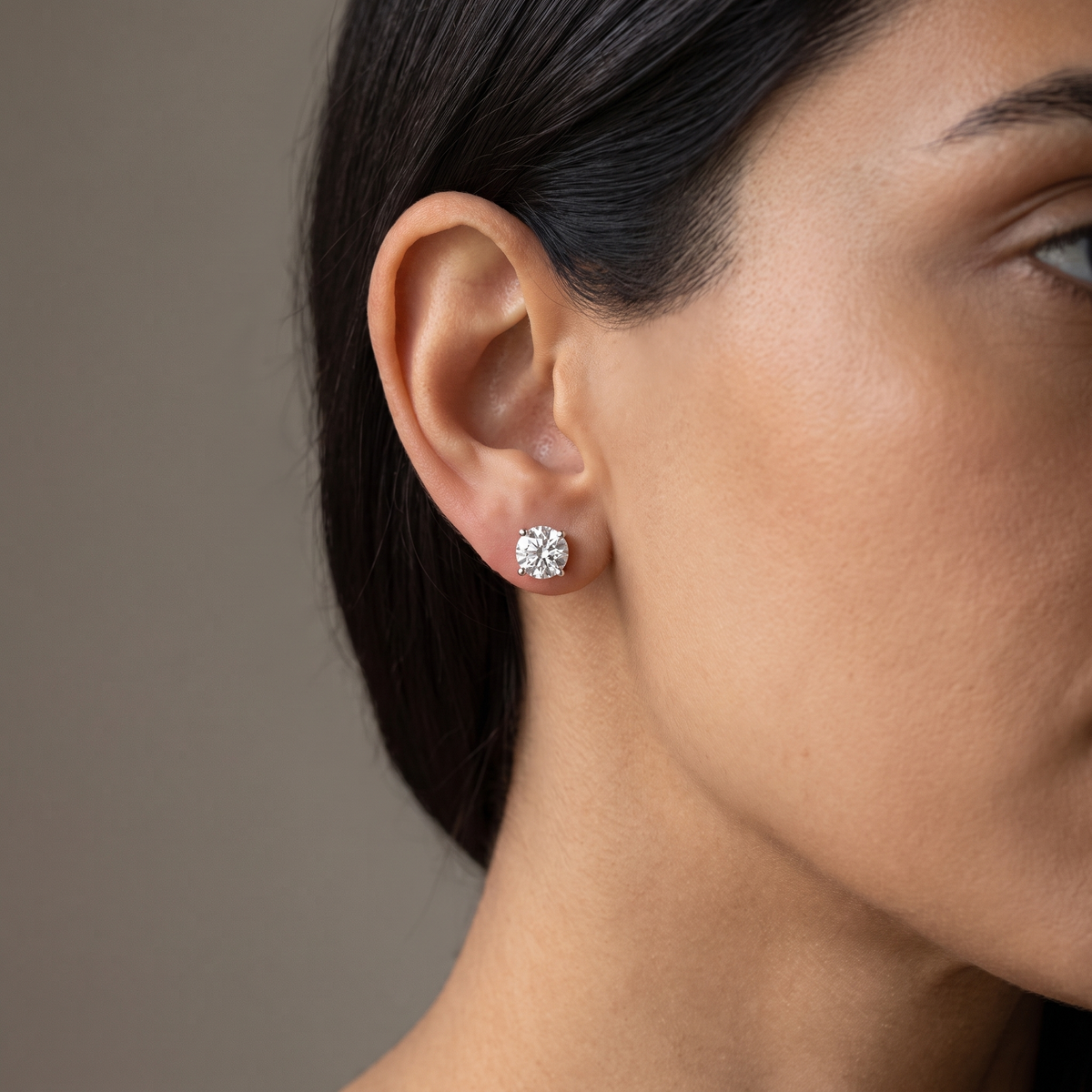 Montier round solitaire stud worn on the ear