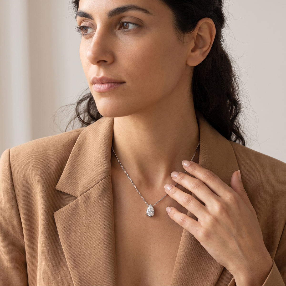 Montier pear pendant styled with a camel blazer